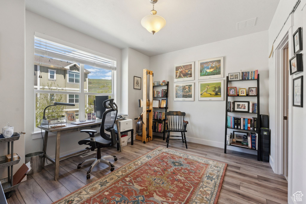 Office featuring wood finished floors and baseboards