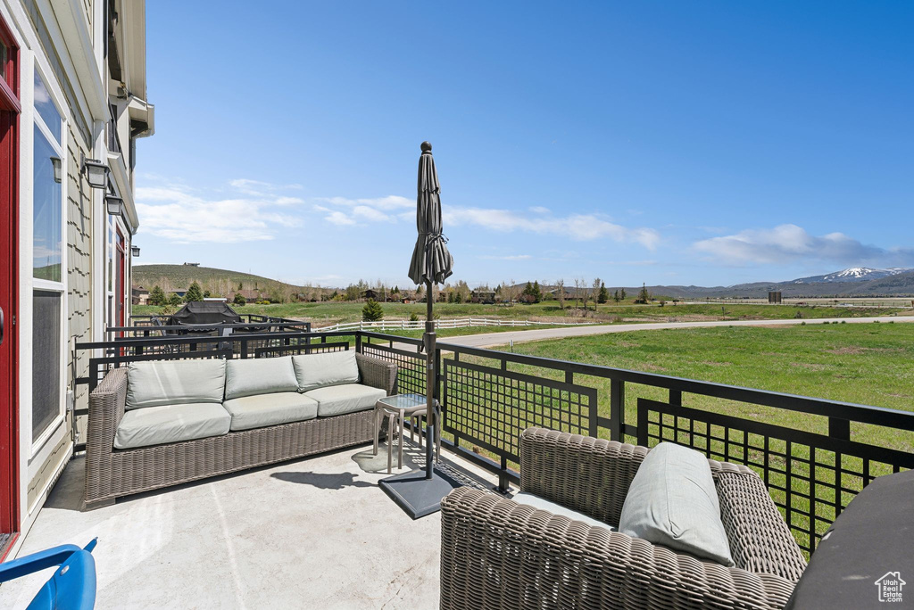 View of patio / terrace featuring an outdoor hangout area, a view of rural / pastoral area, and a mountain view