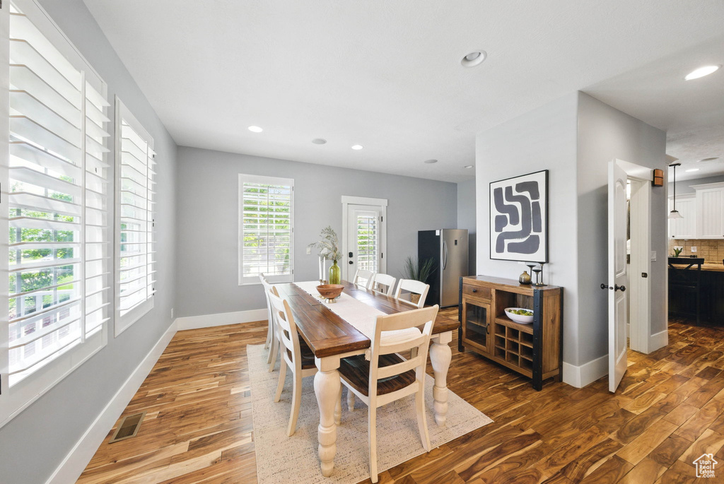 Dining room featuring wood finished floors, baseboards, and recessed lighting