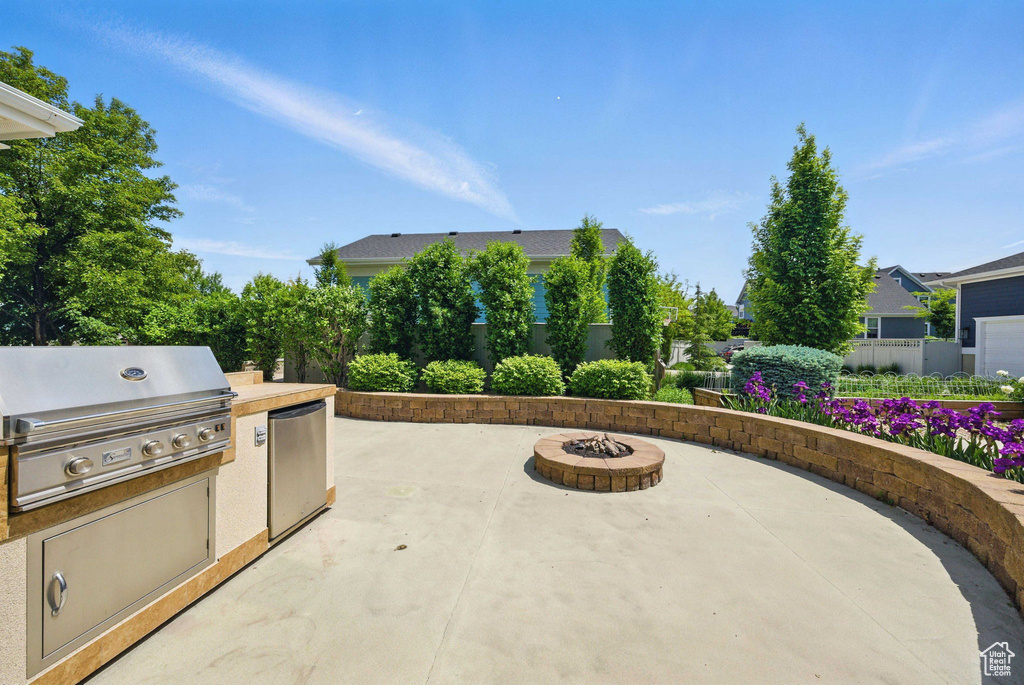 View of patio with a fire pit