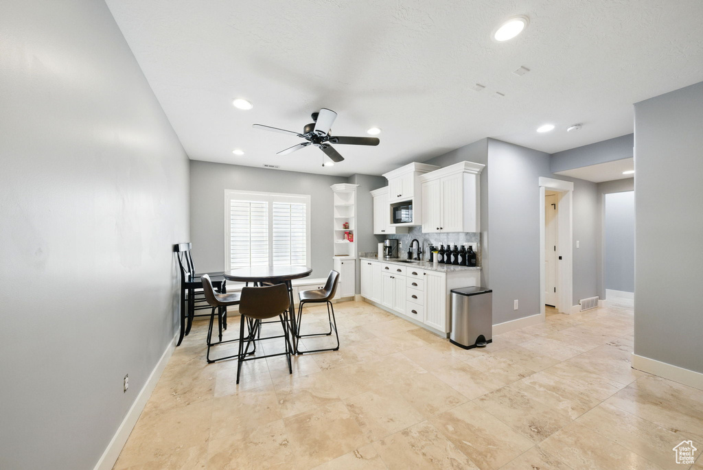 Dining room featuring ceiling fan, baseboards, and recessed lighting