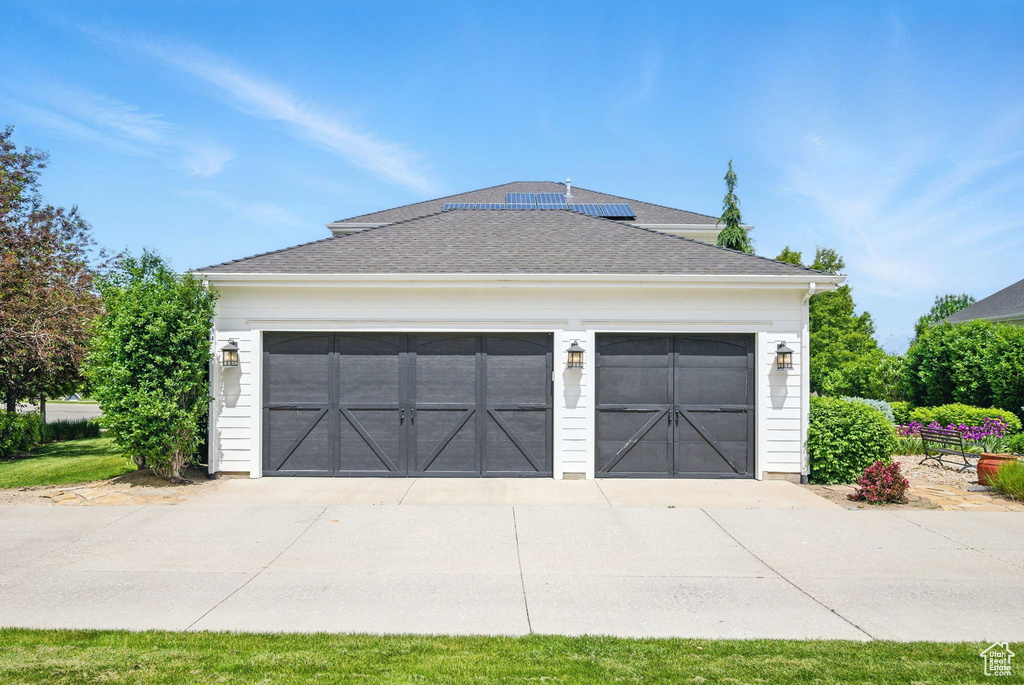 Detached garage featuring solar panels