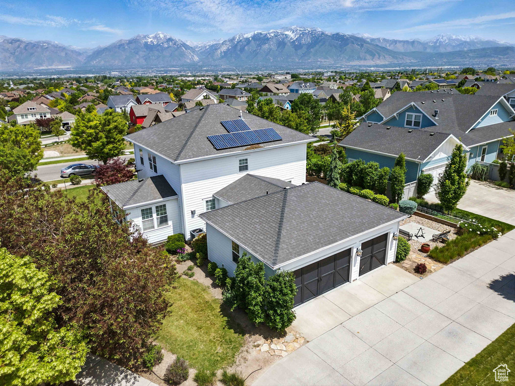 Aerial perspective of suburban area featuring a mountain backdrop