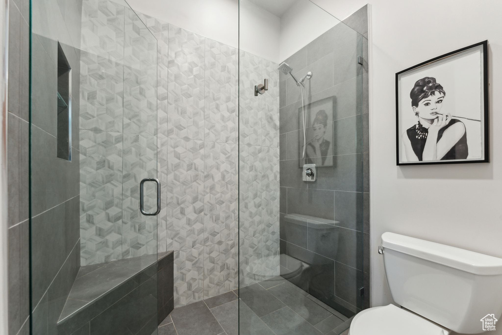 Bathroom featuring toilet and tiled shower