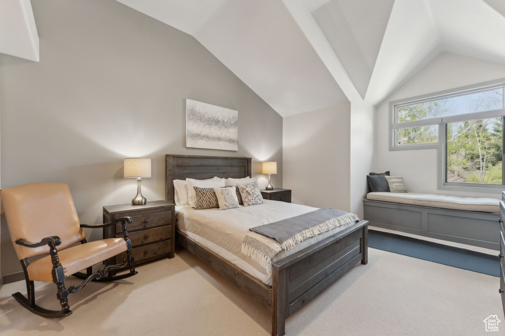 Carpeted bedroom with vaulted ceiling