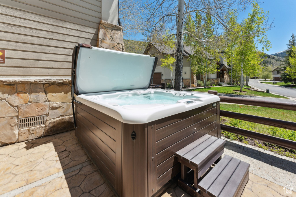 Deck featuring a hot tub and a mountain view