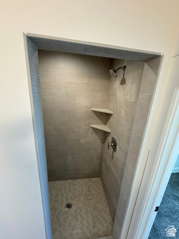 Full bath featuring tiled shower