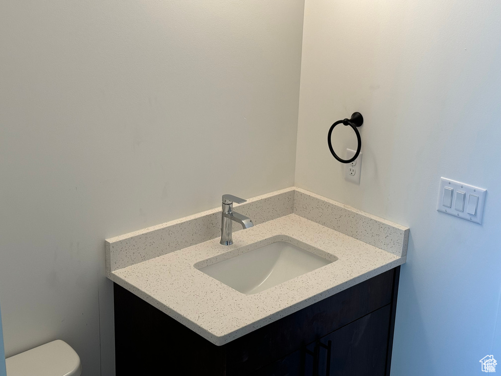 Half bath featuring vanity and toilet