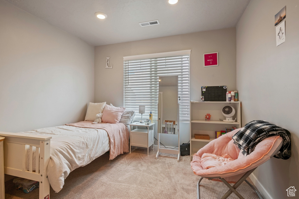 Carpeted bedroom with recessed lighting