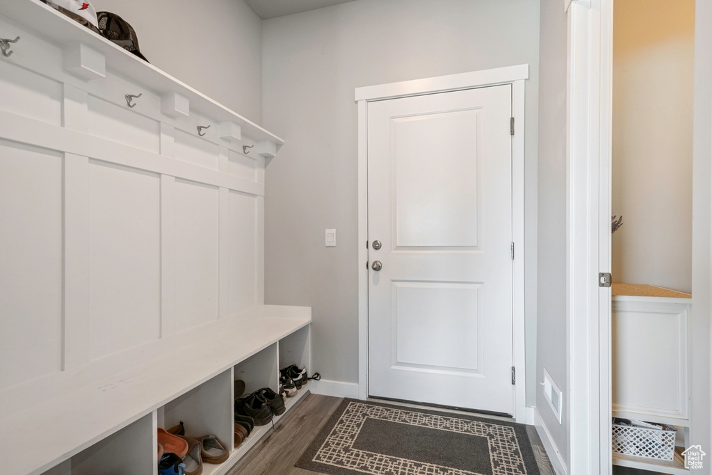 Mudroom featuring baseboards and dark wood-style flooring