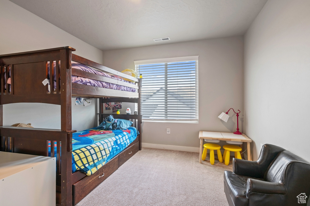 Carpeted bedroom with baseboards
