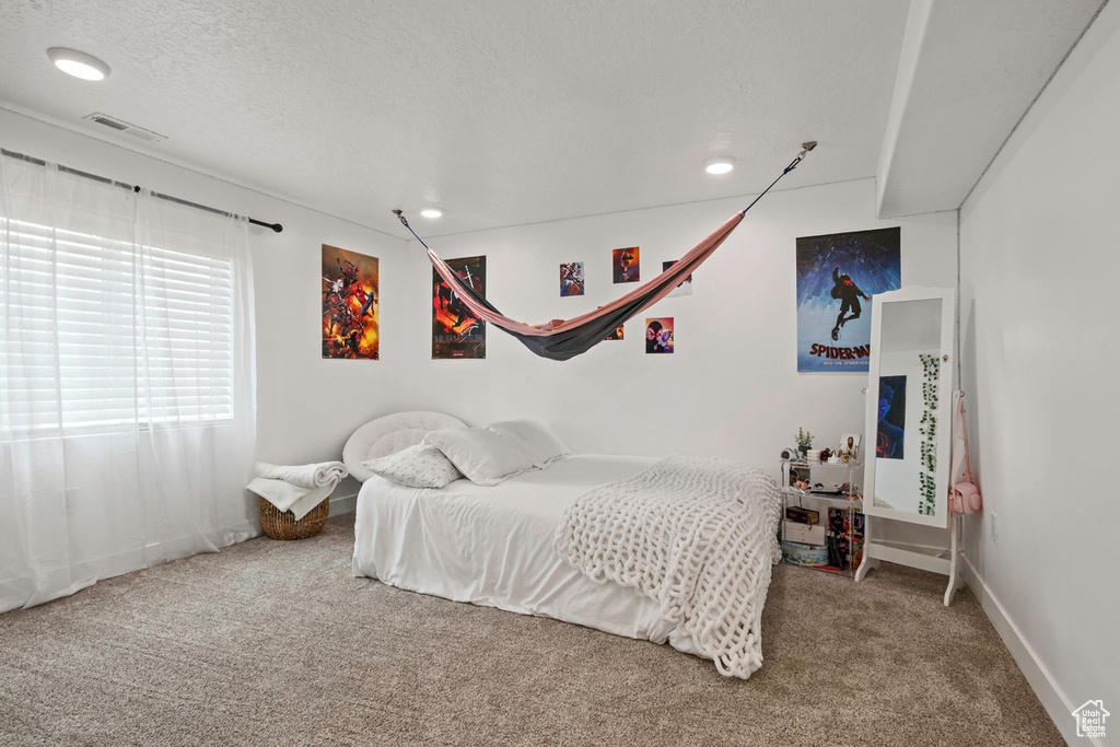 Bedroom featuring carpet floors, recessed lighting, baseboards, and a textured ceiling