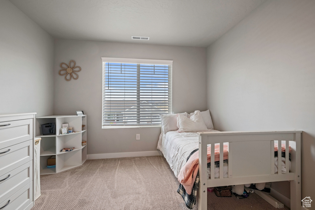Bedroom featuring baseboards and light colored carpet