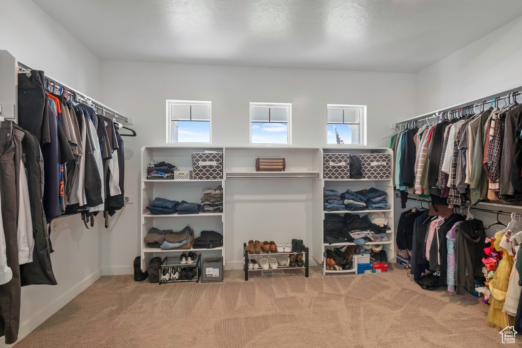 Walk in closet with carpet flooring