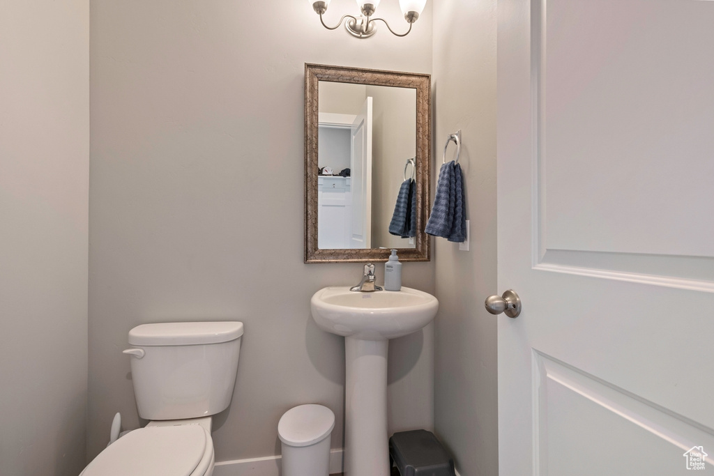 Half bathroom featuring toilet and a sink