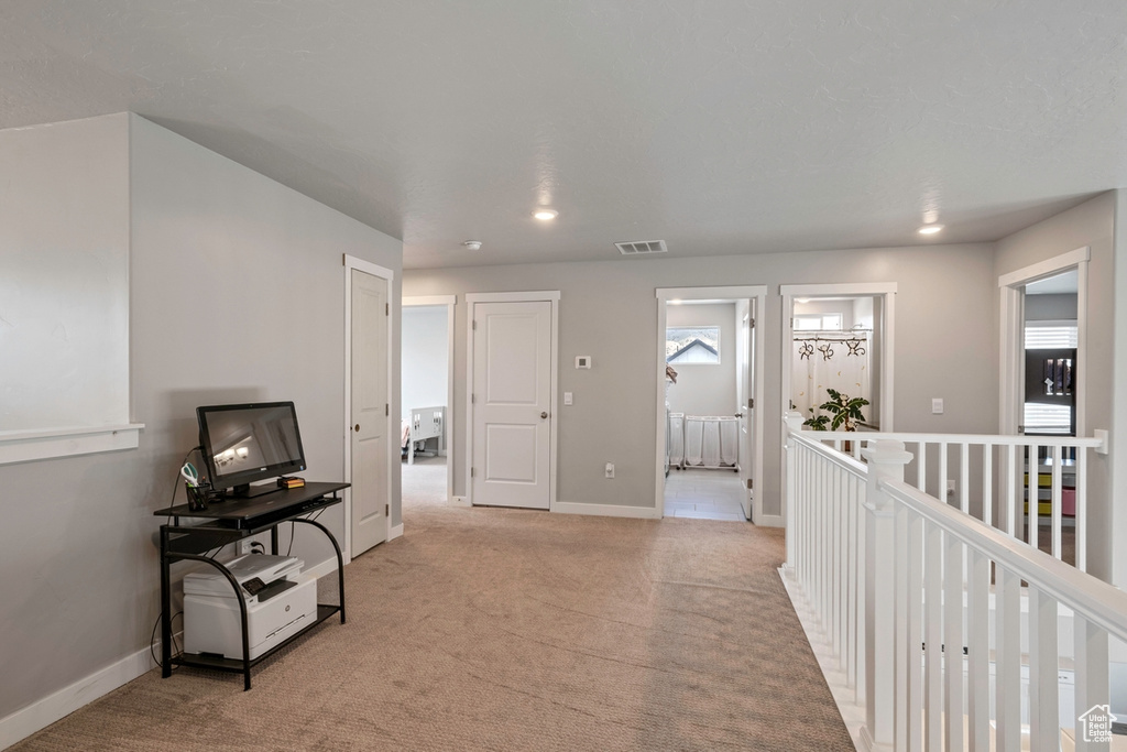 Hallway with carpet flooring, baseboards, and recessed lighting