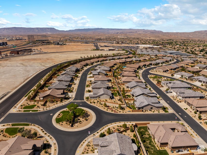 Aerial overview of property's location featuring a mountainous background and nearby suburban area