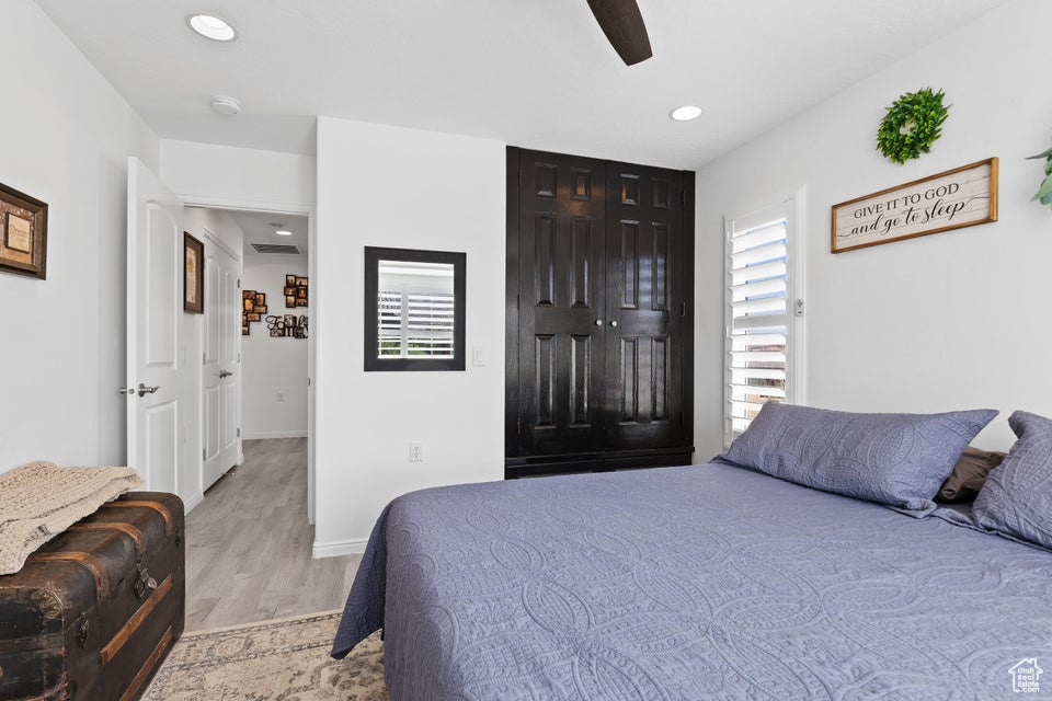 Bedroom with light wood-style floors, recessed lighting, baseboards, and a ceiling fan