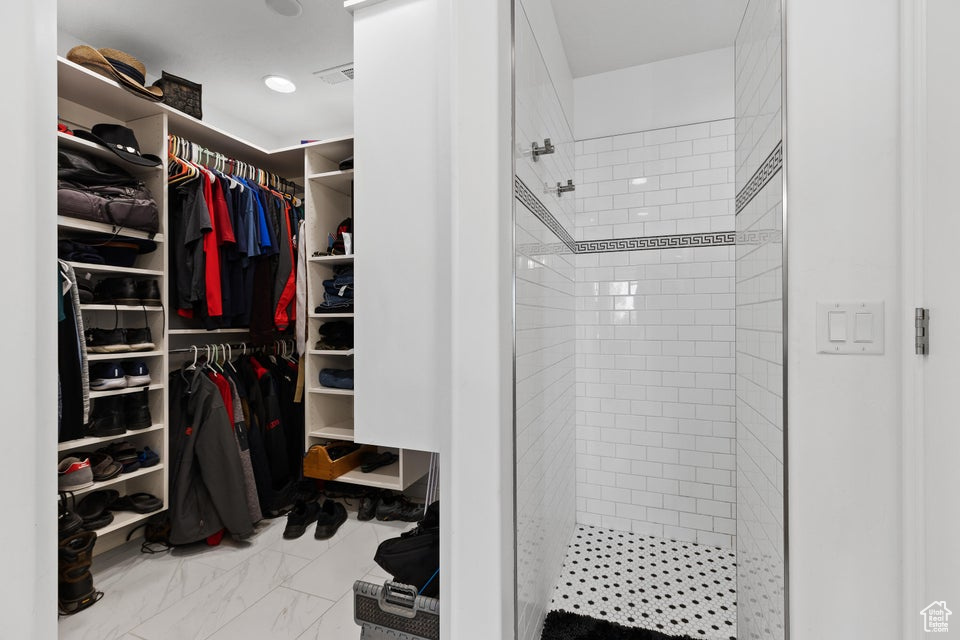 Walk in closet with marble finish flooring