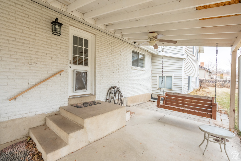 View of patio featuring ceiling fan