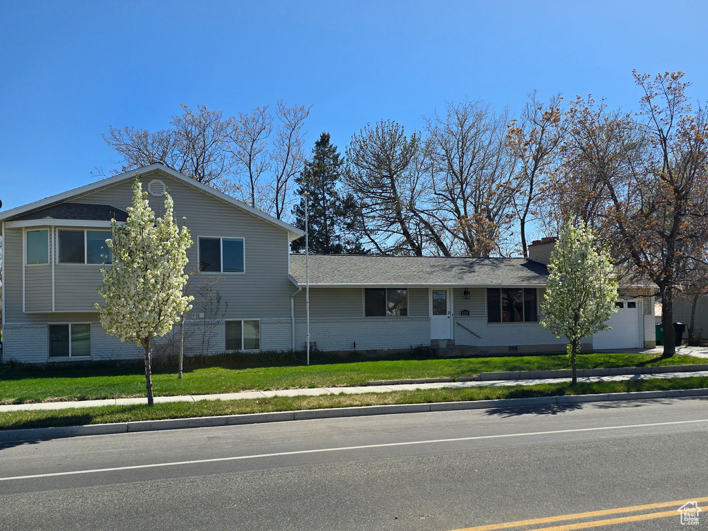 Split level home featuring brick siding