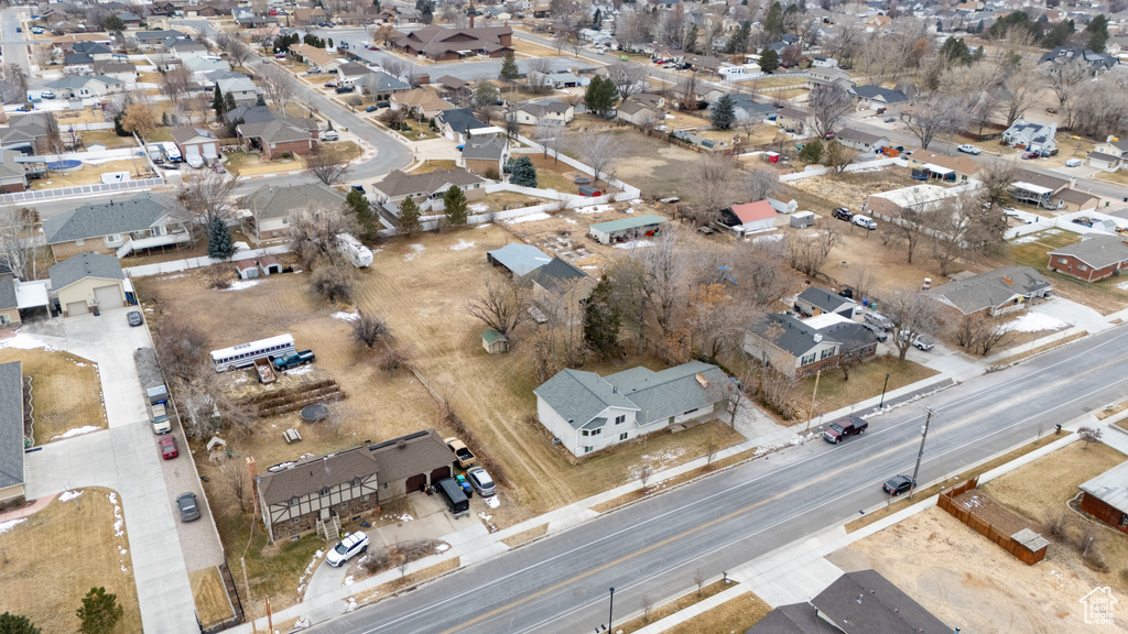 Aerial view of property and surrounding area featuring nearby suburban area