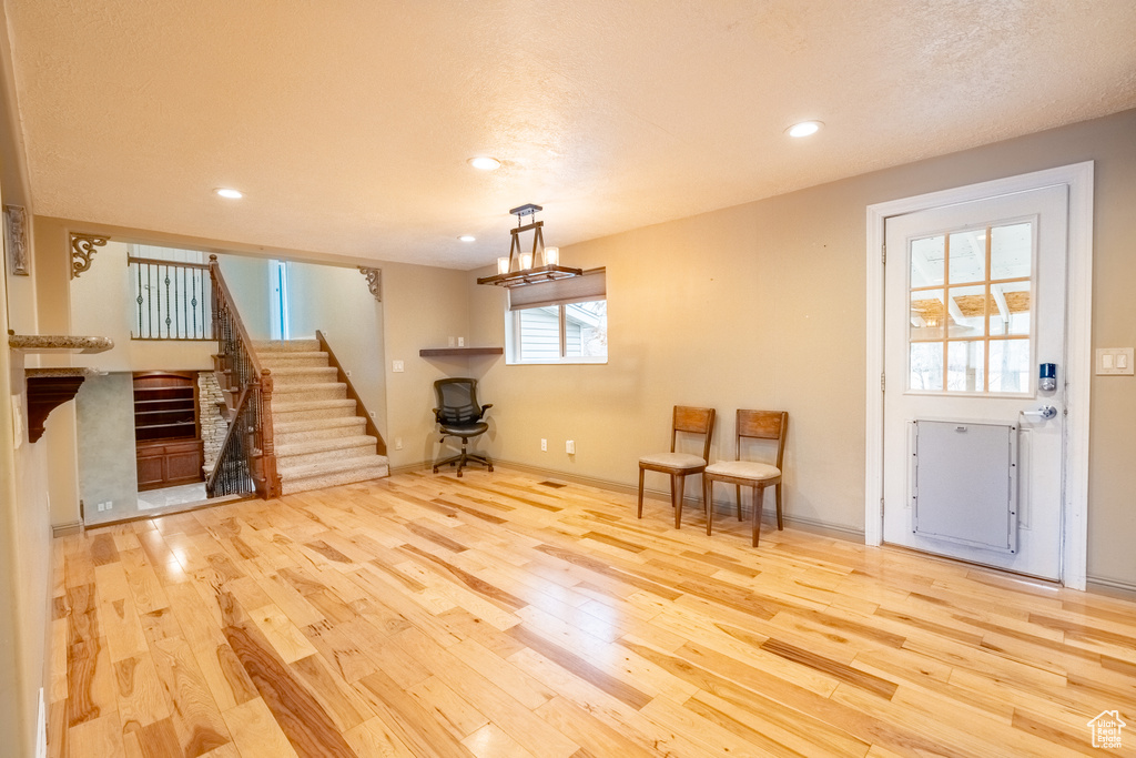 Living room featuring wood finished floors, stairs, recessed lighting, and baseboards