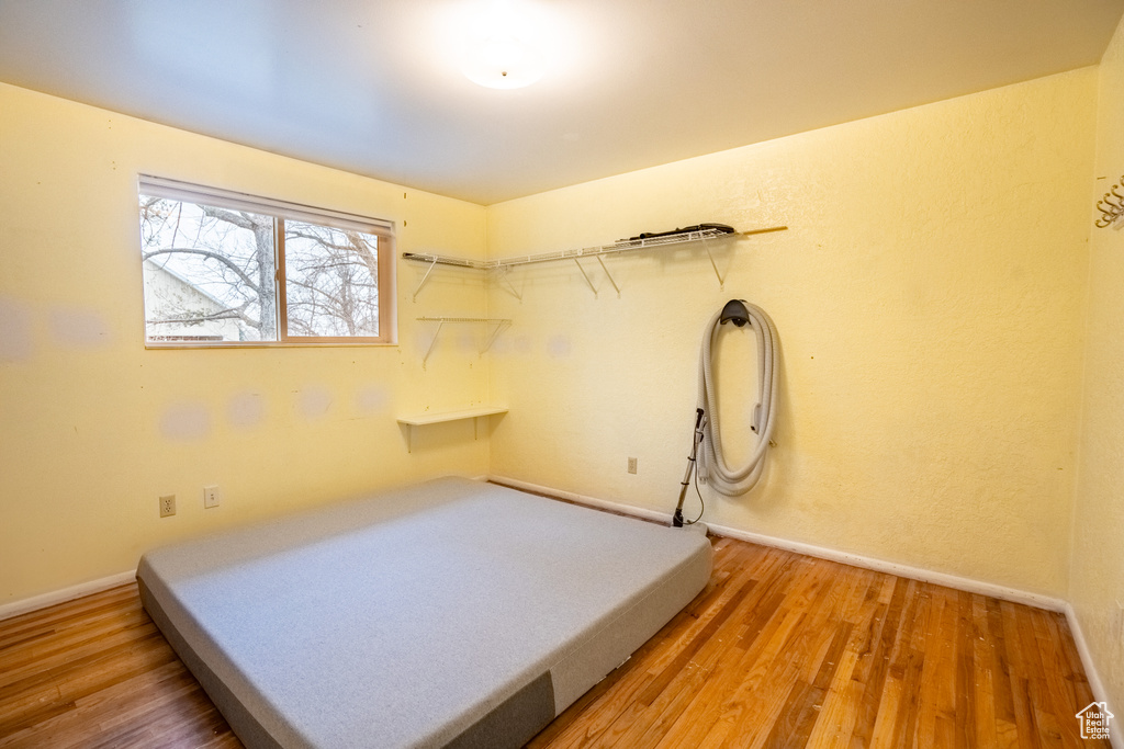 Unfurnished bedroom featuring baseboards and light wood-style flooring