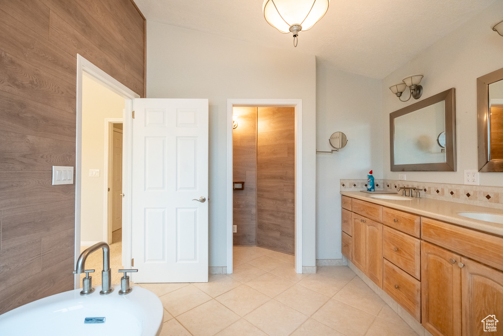 Full bathroom featuring tile patterned flooring and double vanity