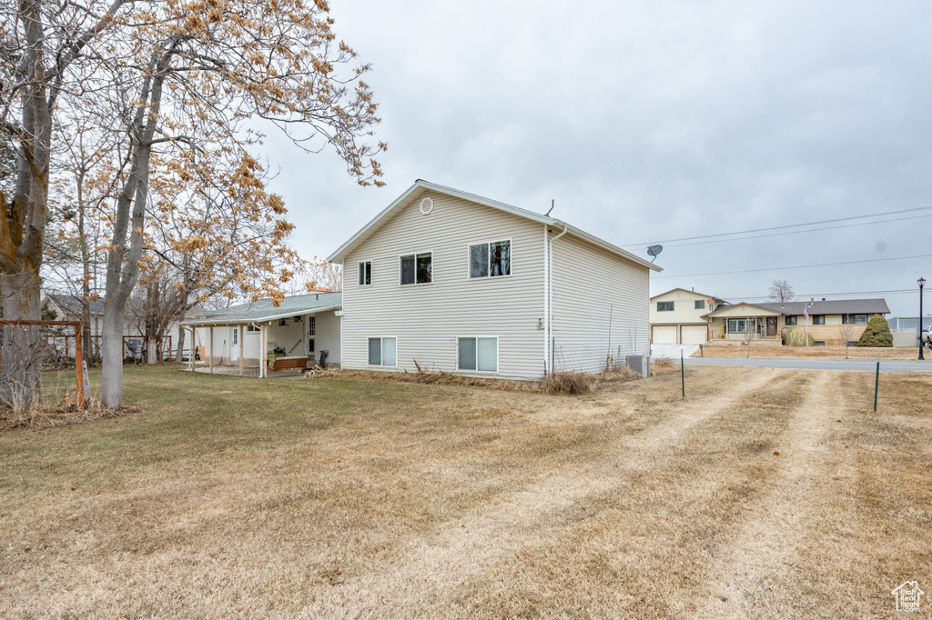 Rear view of property with a lawn
