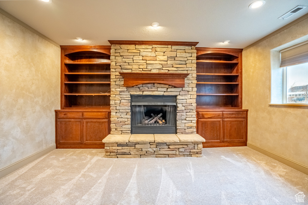 Unfurnished living room with ornamental molding, baseboards, carpet, a fireplace, and recessed lighting