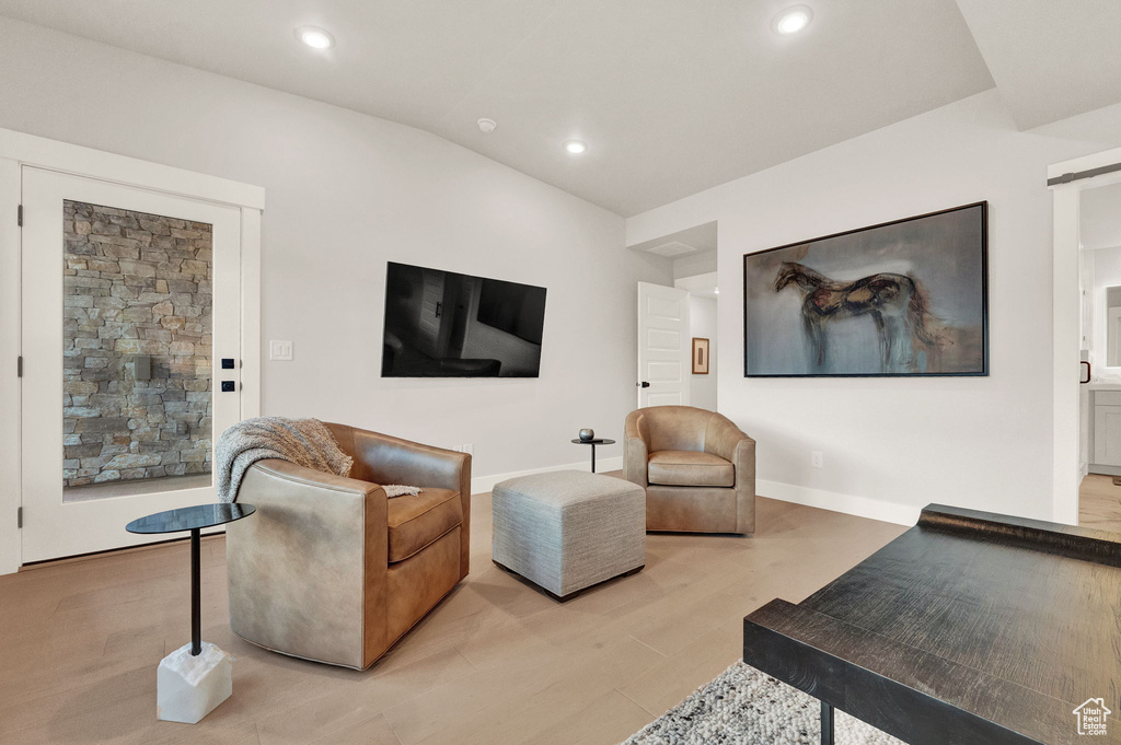 Living area featuring recessed lighting, light wood-type flooring, and vaulted ceiling