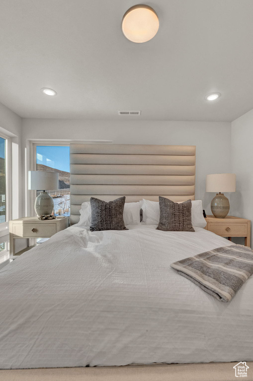 Bedroom featuring multiple windows and recessed lighting