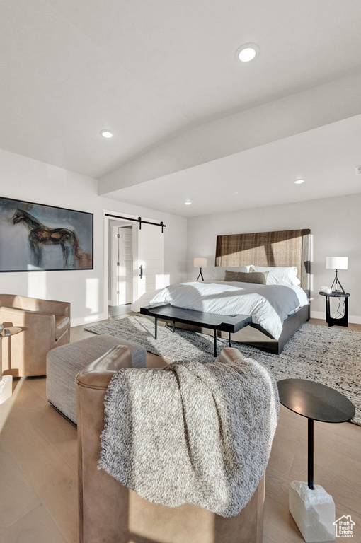 Bedroom featuring baseboards, recessed lighting, and a barn door