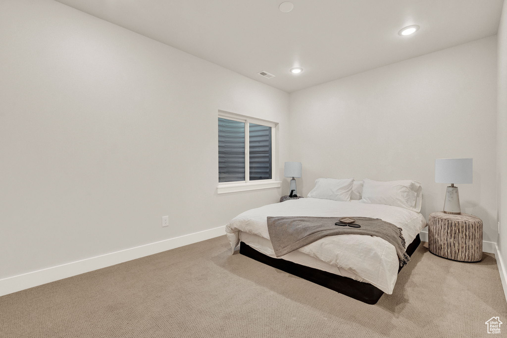 Carpeted bedroom with baseboards and recessed lighting