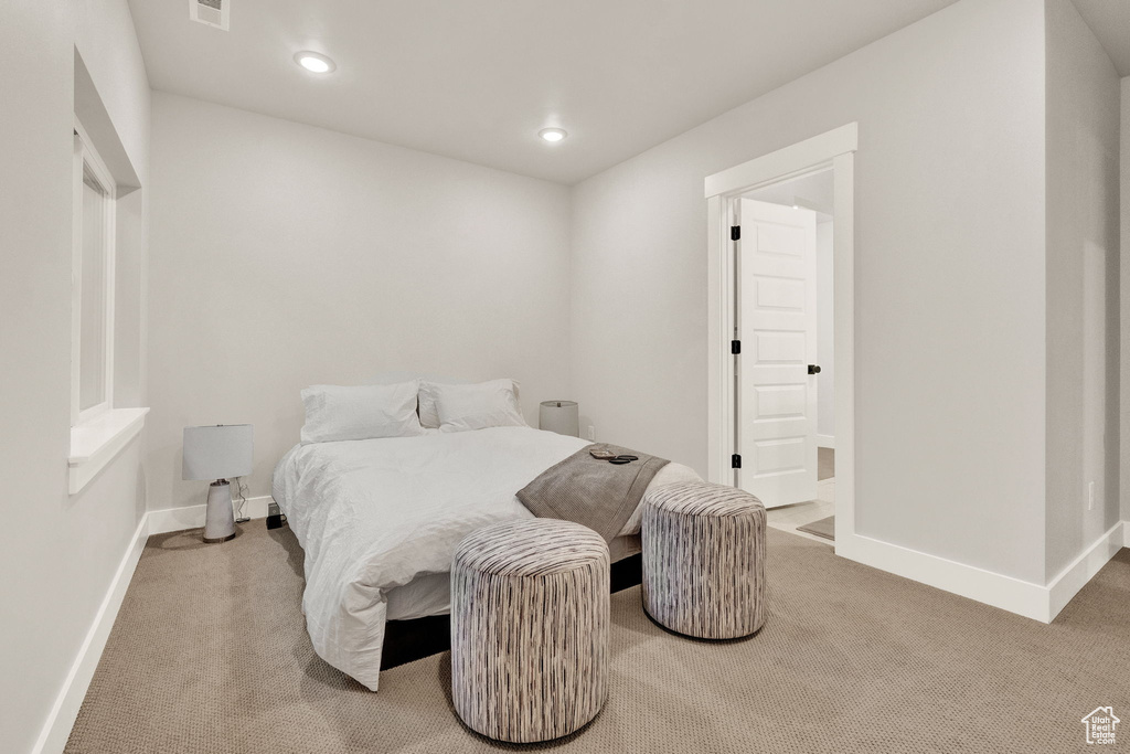 Carpeted bedroom with baseboards and recessed lighting