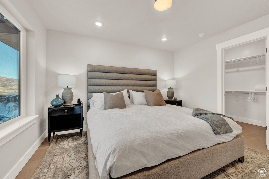 Bedroom featuring a spacious closet, baseboards, recessed lighting, and a closet
