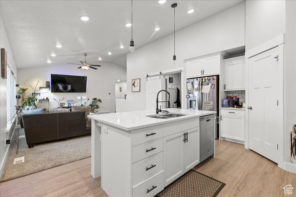 Kitchen featuring a sink, stainless steel dishwasher, light wood-type flooring, a ceiling fan, and recessed lighting