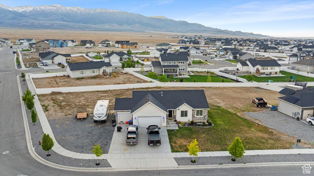 Aerial view of residential area featuring a mountainous background