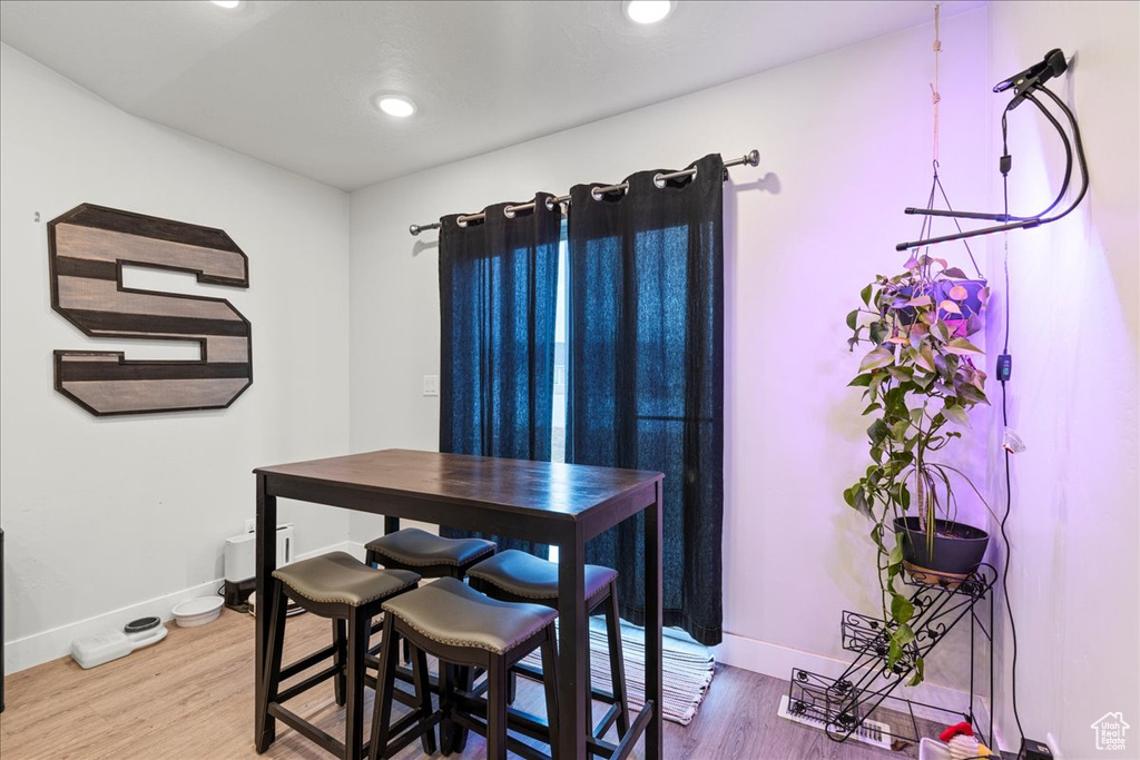 Dining space featuring light wood-type flooring, baseboards, and recessed lighting