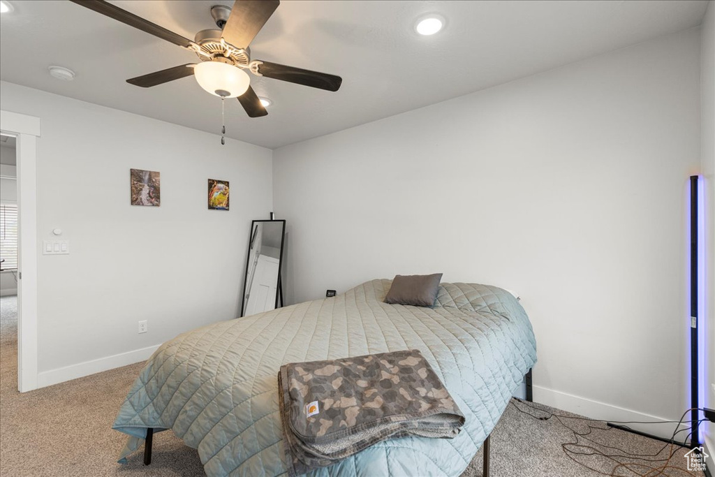 Carpeted bedroom featuring baseboards, recessed lighting, and ceiling fan