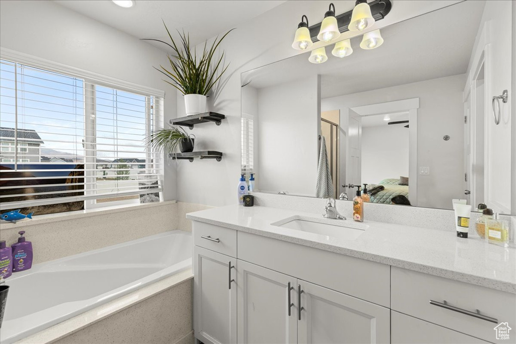 Full bathroom with vanity, a bath, ensuite bath, and a stall shower