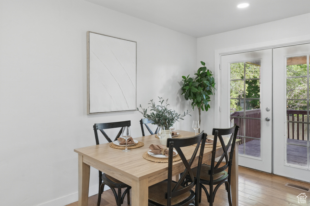Dining space featuring french doors, light wood-style flooring, baseboards, and recessed lighting