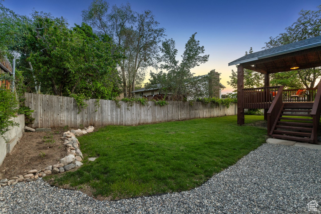 View of yard with a deck and stairway