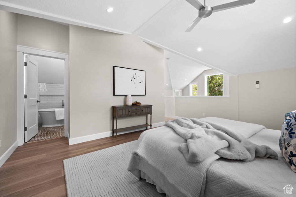 Bedroom featuring wood finished floors, recessed lighting, vaulted ceiling, baseboards, and connected bathroom