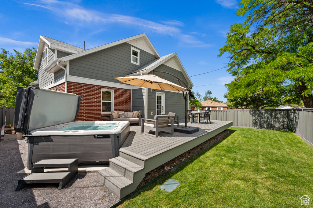 Back of house featuring a wooden deck, a hot tub, brick siding, an outdoor hangout area, and outdoor dining area