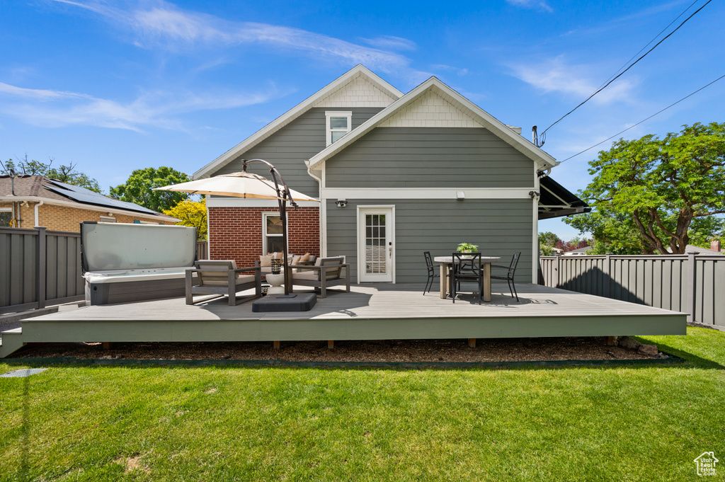 Back of house featuring outdoor lounge area and a wooden deck