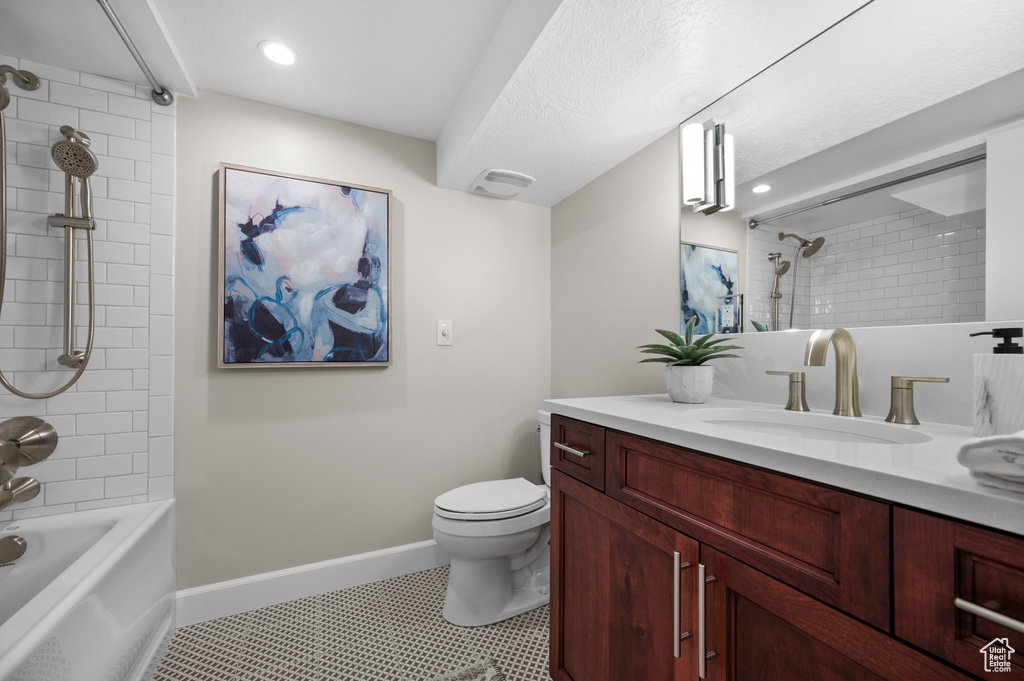 Bathroom featuring vanity, toilet,  shower combination, baseboards, and recessed lighting