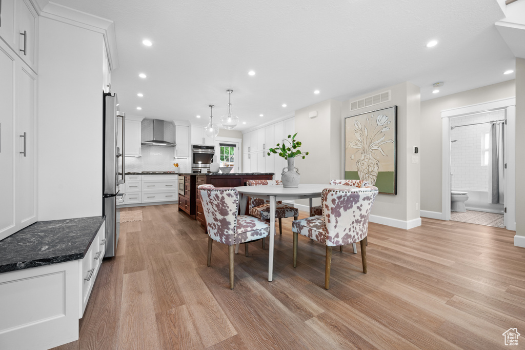Dining space featuring light wood-style floors, recessed lighting, and baseboards