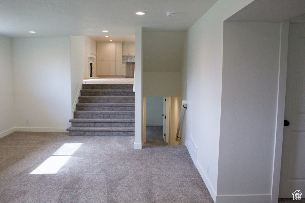 Stairway with carpet, recessed lighting, and baseboards